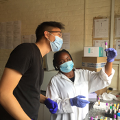 Two researchers in a lab, looking at a test tube