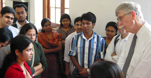NIH Director Dr Francis Collins listens attentively to a young woman among a large group of Indian students