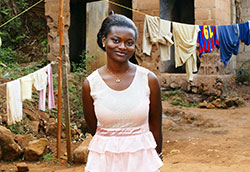 Photo by SylvieBouchard/iStock/Thinkstock, Well dressed young African woman stands outside, laundry hanging on line in background