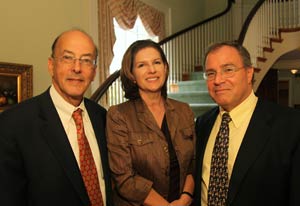 Dr Roger Glass, Dr. Maria C. Freire, and Dr. Derek Yach smile for the camera in the stone house lobby