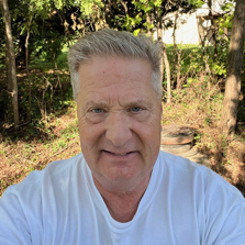 Photo of Bruce Butrum wearing a white shirt and smiling