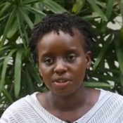 This photo shows Dr. Mainga Hamaluba of KEMRI Wellcome Trust Research Programme standing outside and wearing a white blouse. She's clinical head of the Kenyan program and leader of the snakebite trial funded by CWR.