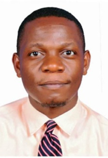 In this headshot of Dr. George Paasi, he wears a white shirt and purple and pink striped tie.