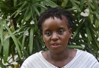 This photo shows Dr. Mainga Hamaluba of KEMRI Wellcome Trust Research Programme standing outside and wearing a white blouse. She's clinical head of the Kenyan program and leader of the snakebite trial funded by CWR.