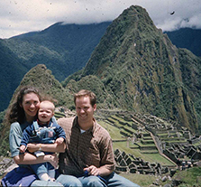Old photo Joseph Zunt with his wife and son, smiling, with Machi Picchu in the distant background