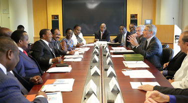 African delegation and NIH leadership seated around a large conference table