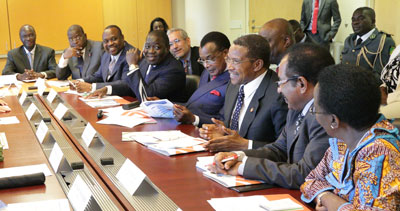 Large delegation of African leaders seated at conference table