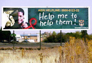 Large outdoor billboard surrounded by grass reads AIDS Helpline, Help me to help them!
