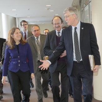 HHS secretary Burwell walks in Clinical Center hallway with NIH Dir Collins NCI Director Varmus and NIH Deputy Director Tabak