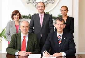 Health Minister Edwin Poots signing MOU with Dr Ted Trimble, Mary Jackson, Dr Michael McBride and Isabel Otero