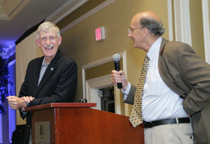 NIH Director Francis Collins and Fogarty Director Roger Glass speak at podium at fellows and scholars anniversary celebration