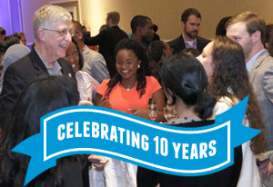 NIH Director Francis Collins mingles with Fogarty fellows and scholars alumni and participants, ribbon reads celebrating 10 year