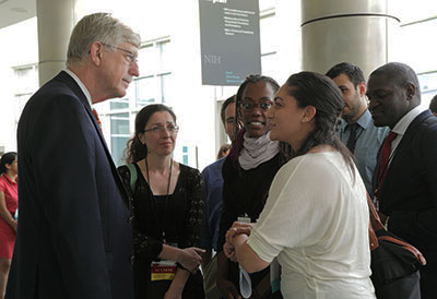 Dr. Francis Collins interacts with a few early-career scientists during a busy conference
