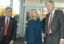 Dr Anthony Fauci walks next to Secretary Hillary Clinton, who speaks with Dr. Francis Collins while exiting a building.