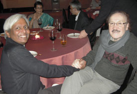 Dr. K. VijayRaghavan and Dr. Maharaj K. Bhan seated at a banquet table shaking hands