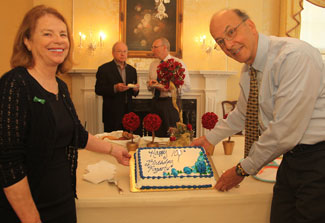 Mary Fogarty McAndrew and Fogarty Director Dr Roger Glass stand by birthday cake