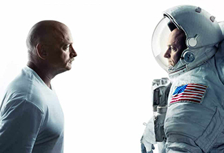 The photo shows retired astronauts Mark and Scott Kelly, identical twin brothers who participated in the NASA Twins Study, standing face to face. Mark, who remained on earth, is on the left wearing a white shirt, while Scott, who spent 340 days aboard the International Space Station, is on the right wearing an astronaut suit.