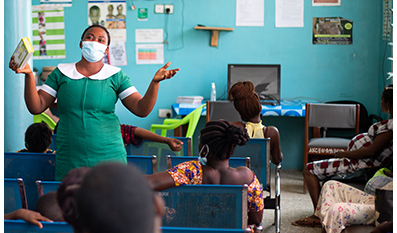 A midwife counsels pregnant women in a classroom in Ghana