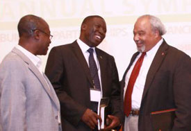 Ambassador Eric Goosby speaks with two other men at 2012 MEPI symposium