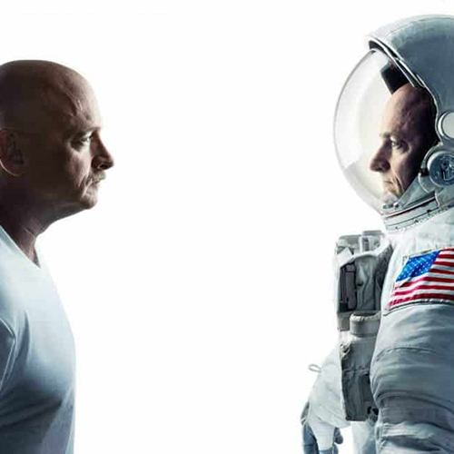 The photo shows retired astronauts Mark and Scott Kelly, identical twin brothers who participated in the NASA Twins Study, stand