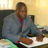 Dr. Sam Phiri seated at a desk