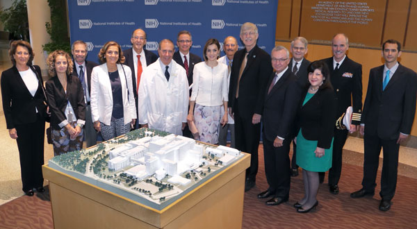 Queen Letizia of Spain and many NIH and Fogarty leaders pose for camera in lobby of NIH Clinical Center