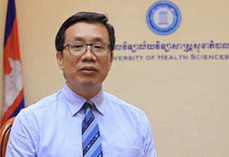 Headshot of Dr. Vonthanak Saphonn, Cambodia flag and University of Health Sciences Cambodia seal in background