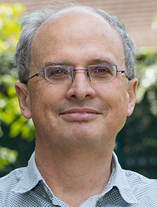 Headshot of Scott Hazelhurst, wearning glasses, smiling