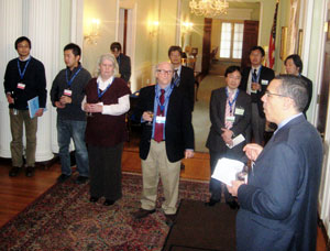 A group of reception attendees look on as Dr. Michael Johnson speaks.