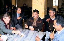 PHOTO: five men seated around table smoking water pipes