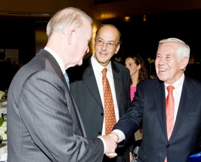 Sen. Richard Lugar greets Dr. Charles Sanders of the NIH Foundation at the Fogarty dinner while Dr. Roger Glass looks on.