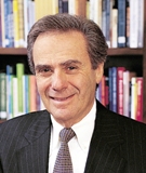 Dr. Allan Rosenfield in front of a bookcase